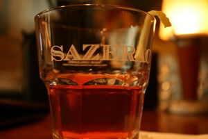 A sazerac strained into
                     a rocks glass and garnished with a twist of lemon rind.