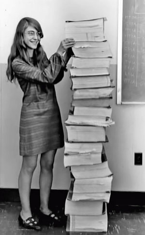 Image of Margaret Hamilton standing next to the Apollo 11 source code